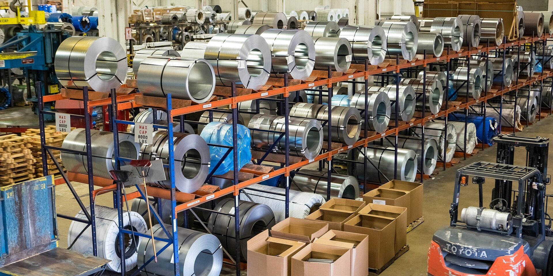 steel-4395773_1920 rolls of steel product lines in a warehouse