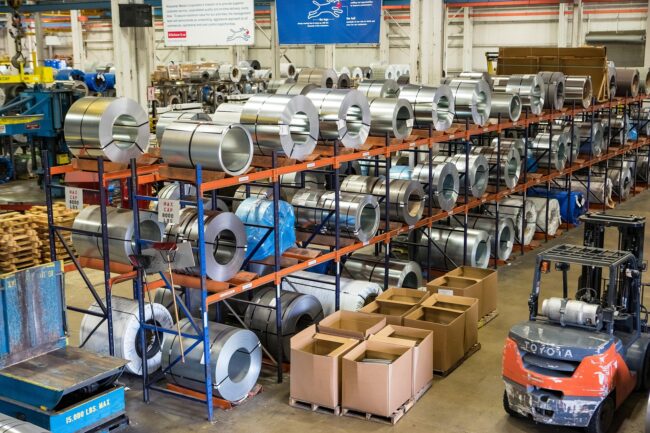 steel-4395773_1920 rolls of steel product lines in a warehouse