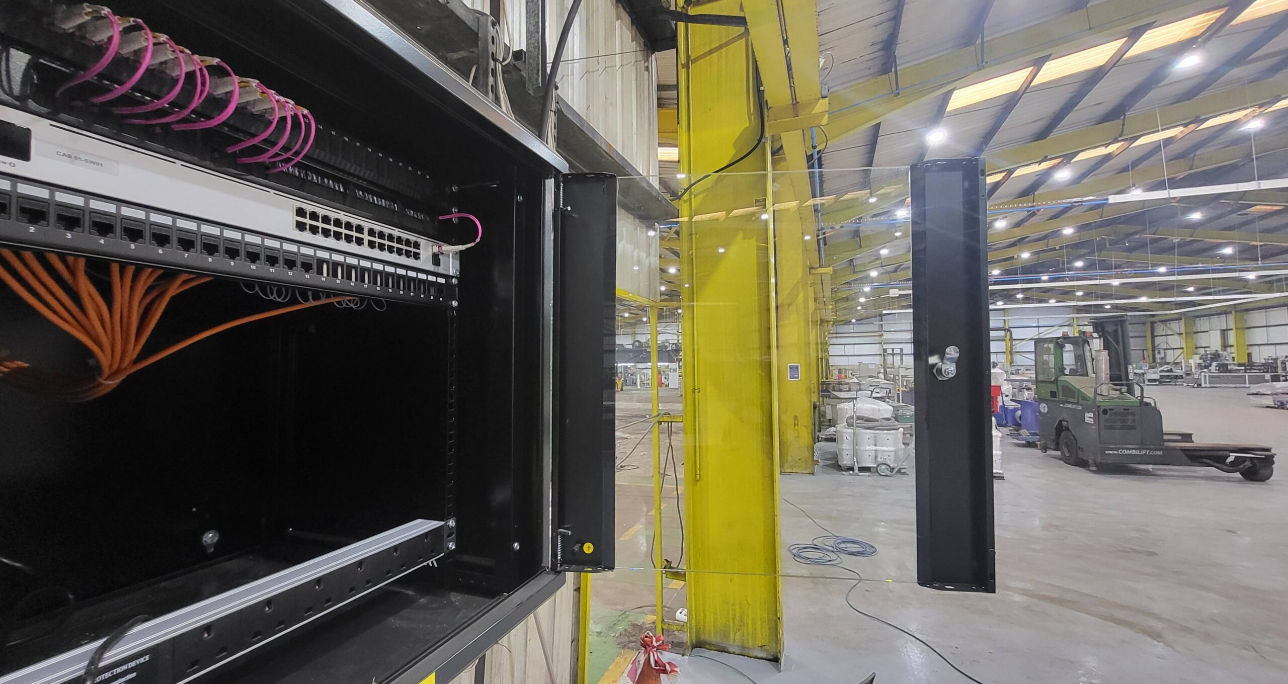 20250326_130810 A high speed network rack in an industrial warehouse.